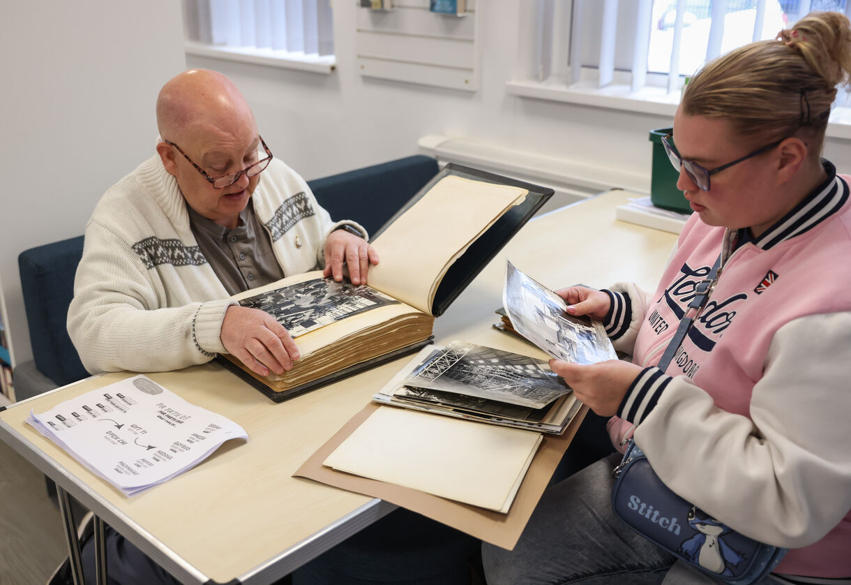 Reminiscing over old photographs at Rhymney Library
