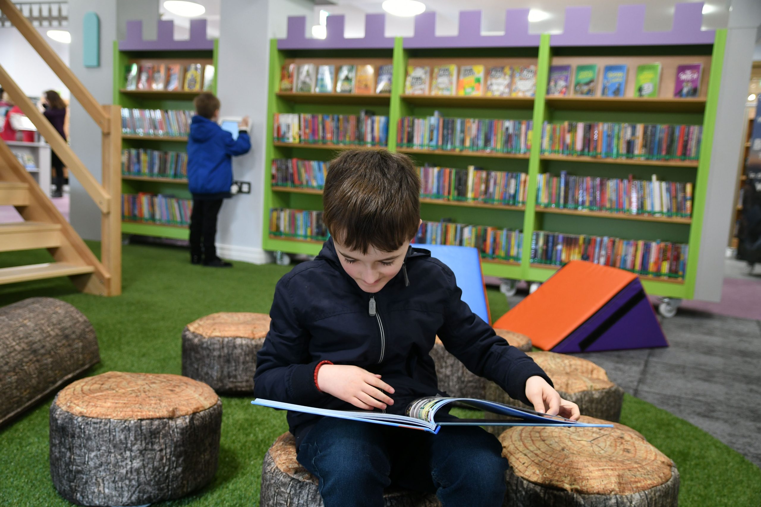 Boy reading at Riverside Library